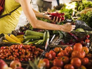 man-choosing-vegetable-from-vegetable-stall-supermarket.jpg